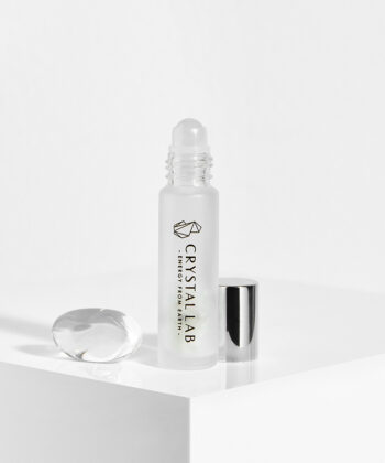 En hvid baggrund med en roll on med minikrystaller. Bjergkrystal