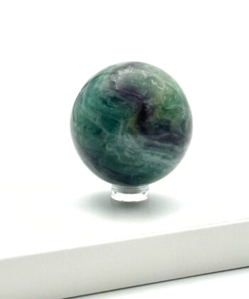 Grøn flourit krystalkugle med lilla detaljer