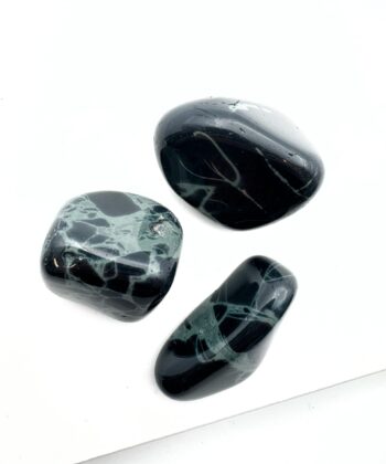 sorte og grønne runde krystaller på hvid baggrund