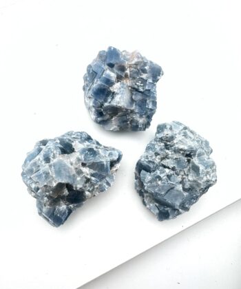 Blågrå rå krystaller på hvid baggrund