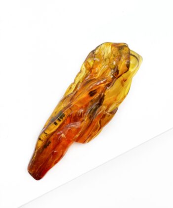Cognac farvet freeform blødt poleret stykke rav på hvid baggrund